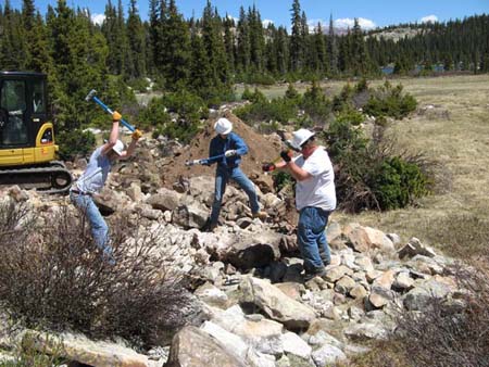 04-Bluebell Lake Stabilization, hand crew trying to break up concrete structure with sledge hammers, used stinger attachment to finish job